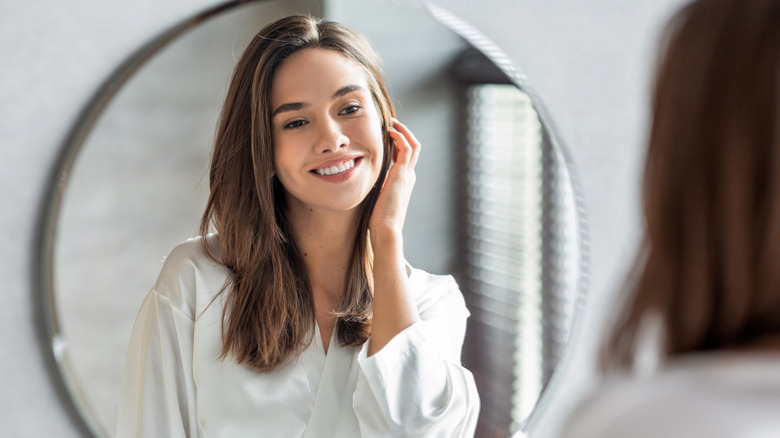 woman smiling in mirror