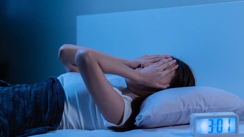 Stressed woman in bed