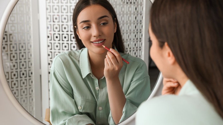 woman applying lip liner
