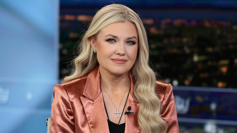 Erika Kirk sitting, wearing a copper suit