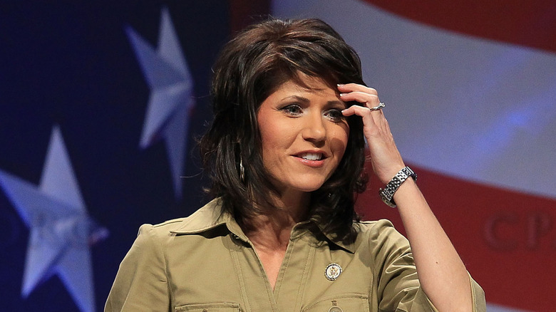 Kristi Noem walks outside