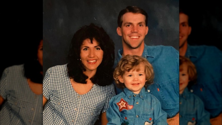 Kristi Noem poses for a professional photo with her husband and young son