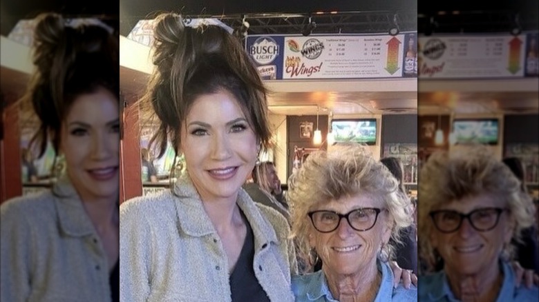 Krisi Noem takes a photo with a friend while out at a bar