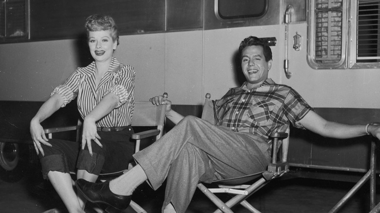 Lucille Ball and Desi Arnaz in front of a trailer