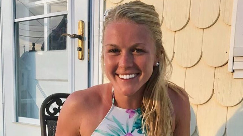 Karoline Leavitt smiles in a photo with a tribute to her dog