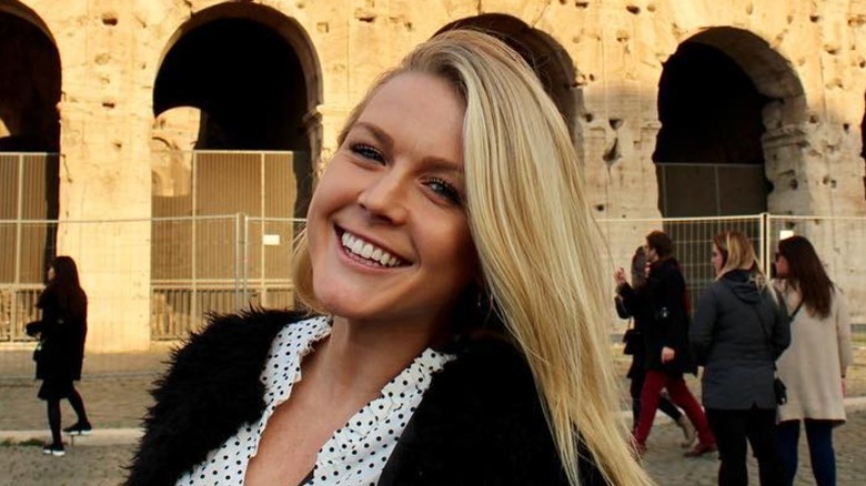 Karoline Leavitt poses in front of the Colliseum