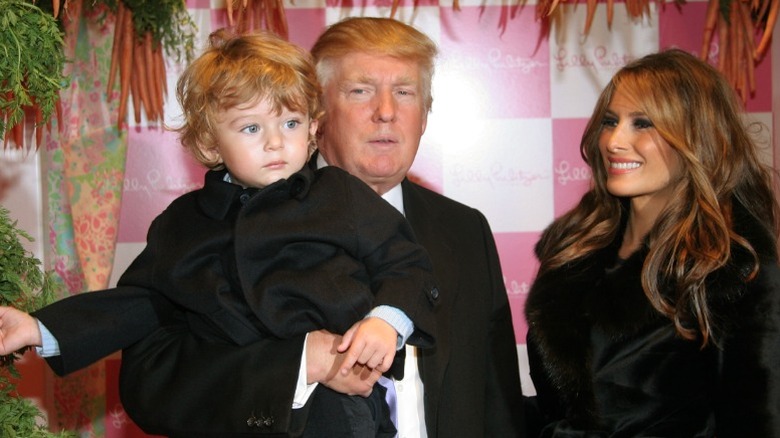 Donald Trump holds son Barron as mother Melania looks on