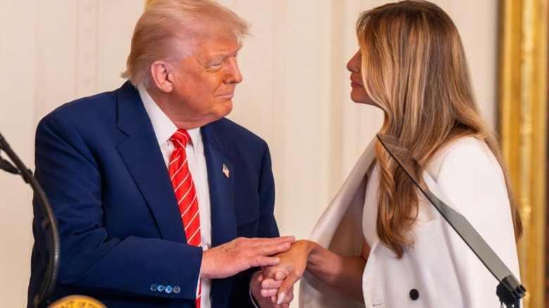 Donald and Melania Trump holding hands