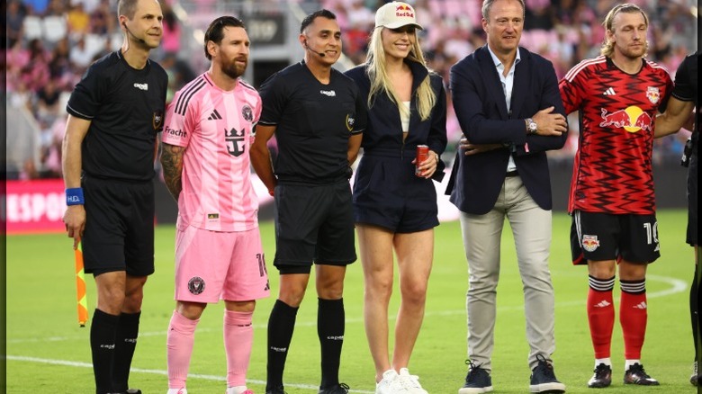 Lindsey Vonn poses at a Miami soccer game, with Lionel Mess in pink