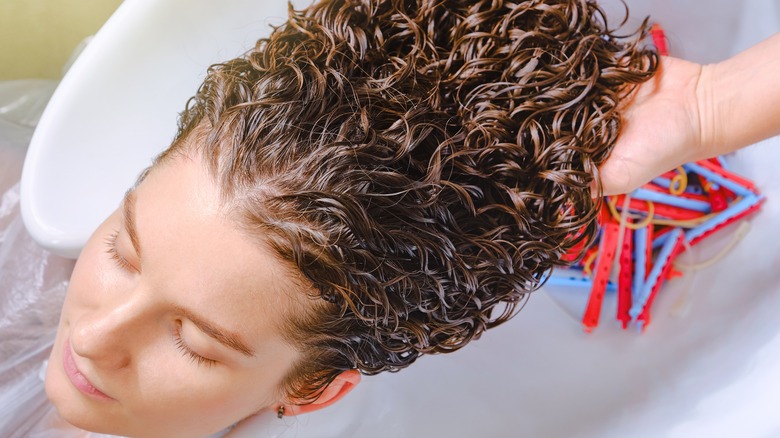 woman having permed hair shampooed