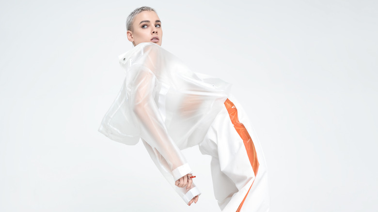 Female model wearing futuristic white outfit