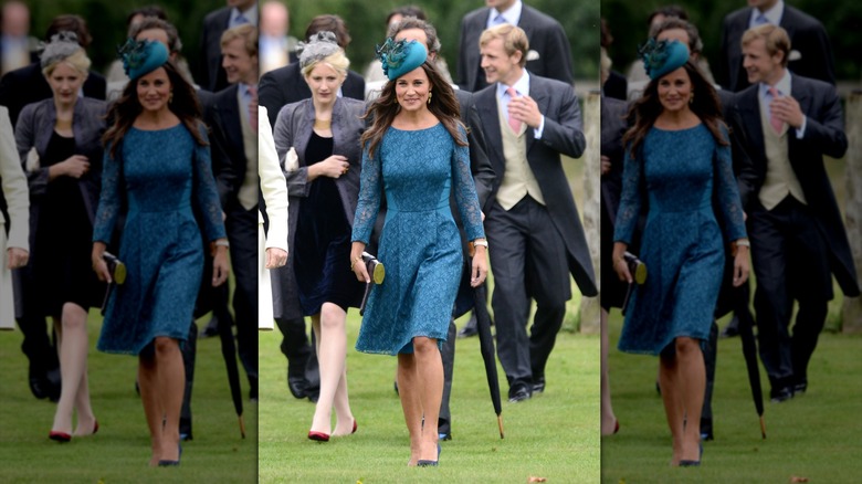 Pippa Middleton in a blue dress walking on the grass