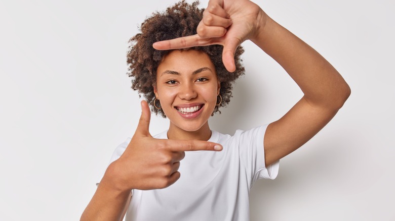 Woman framing face in hands