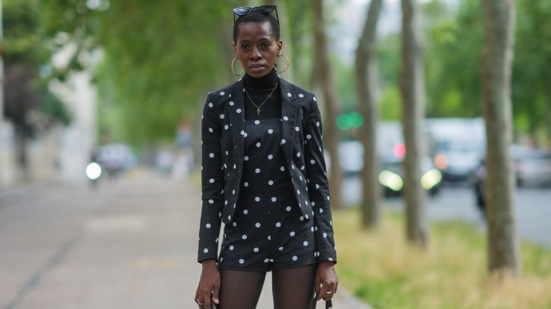 woman wearing a polka dot playsuit with matching blazer