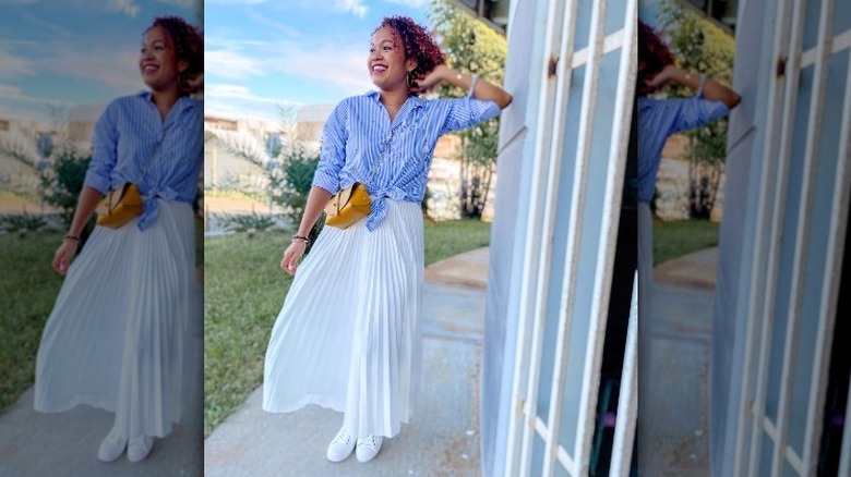 Woman in long white skirt and blue shirt