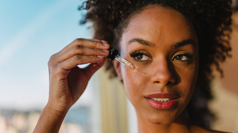 Woman applying face oil