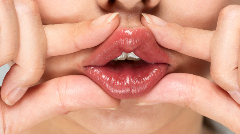 Woman massaging lips
