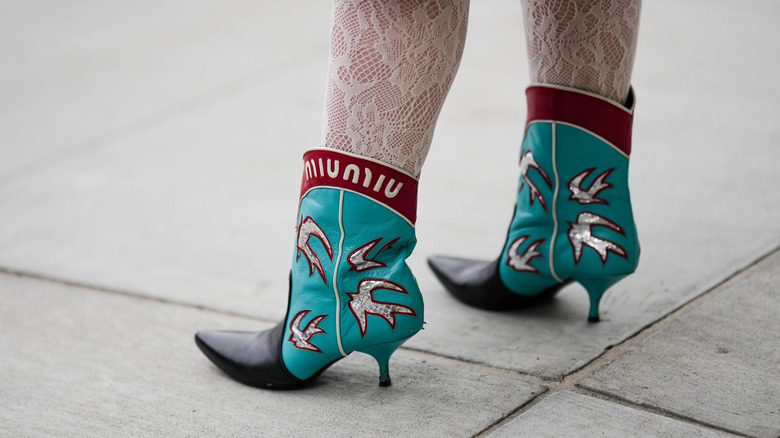 woman wearing printed pointed boots