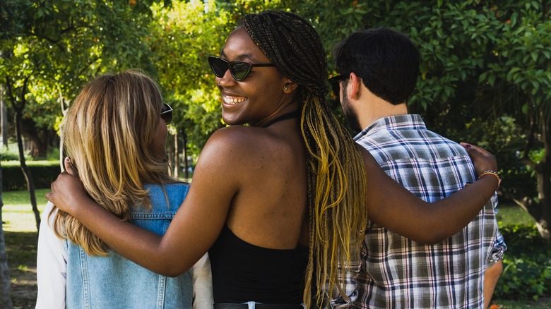 Three people walking together happily