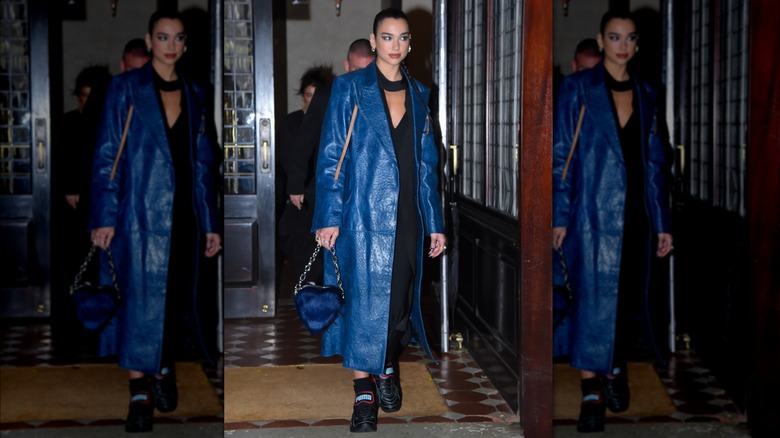 woman in blue leather trench