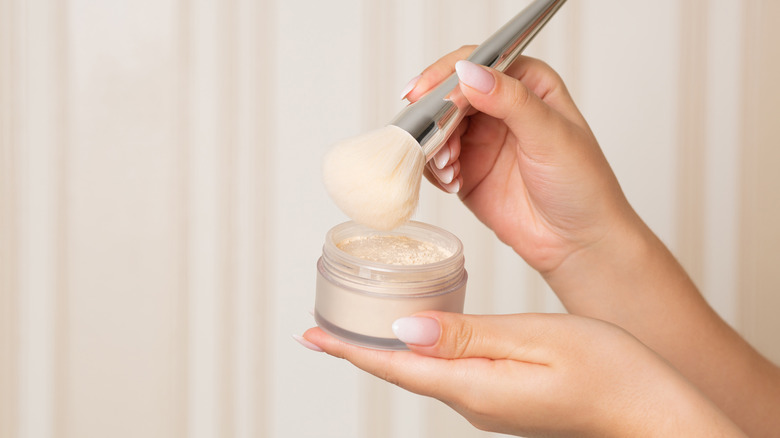 Woman holding loose powder