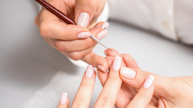 Person getting a manicure.