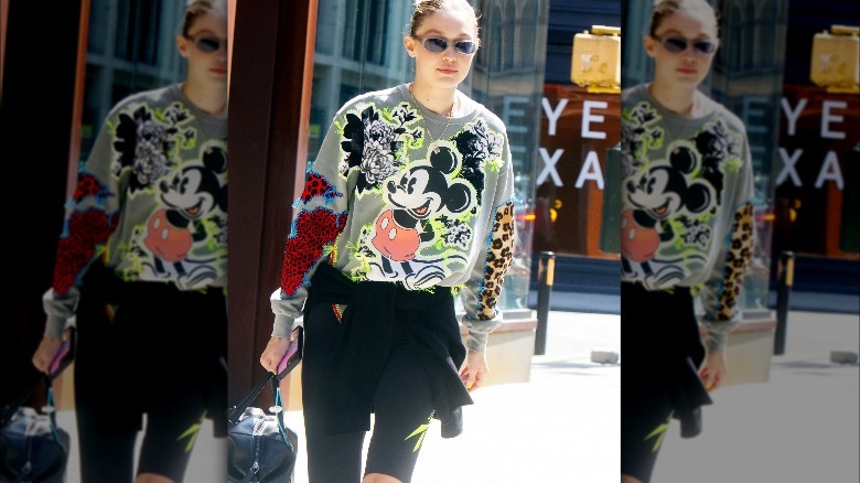 Gigi Hadid in crewneck sweatshirt and biker shorts