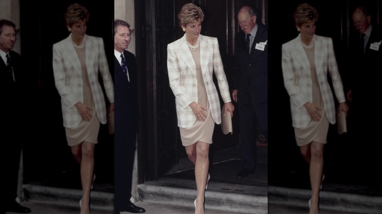 Princess Diana wearing a revealing dress with a white coat in 1994.