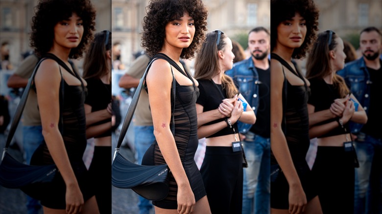 Woman wearing black dress and Mugler bag