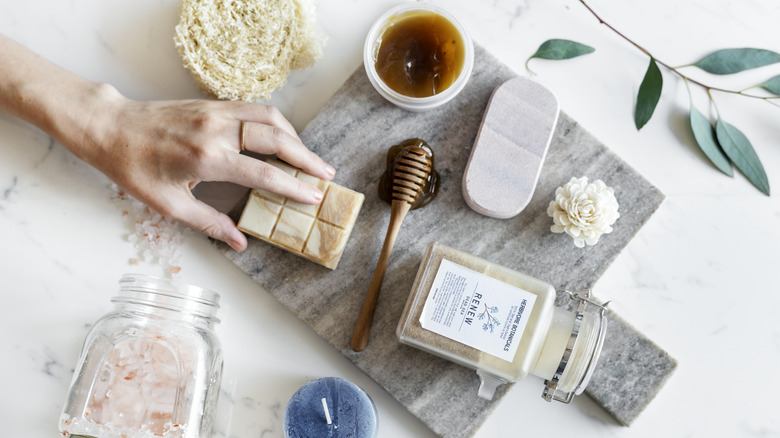 hand reaching for skincare products