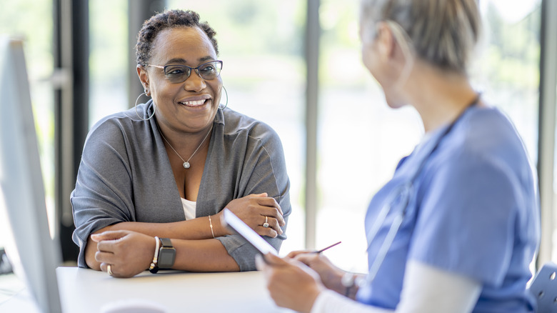 Woman talking with female doctor
