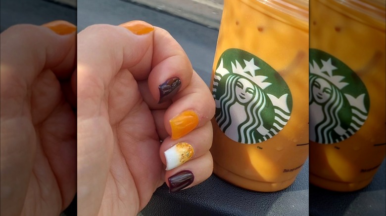 Pumpkin nails next to a PSL