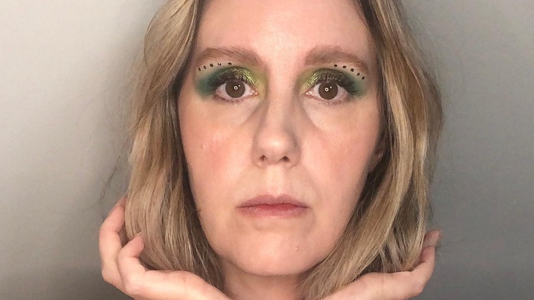 Woman wearing purple face gems