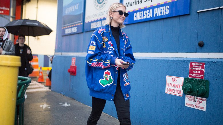 woman wearing oversized racing jacket