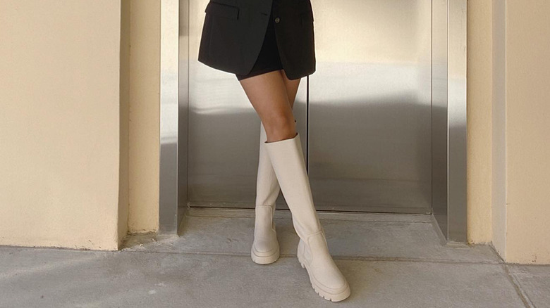 Knee-high cream-colored rain boots