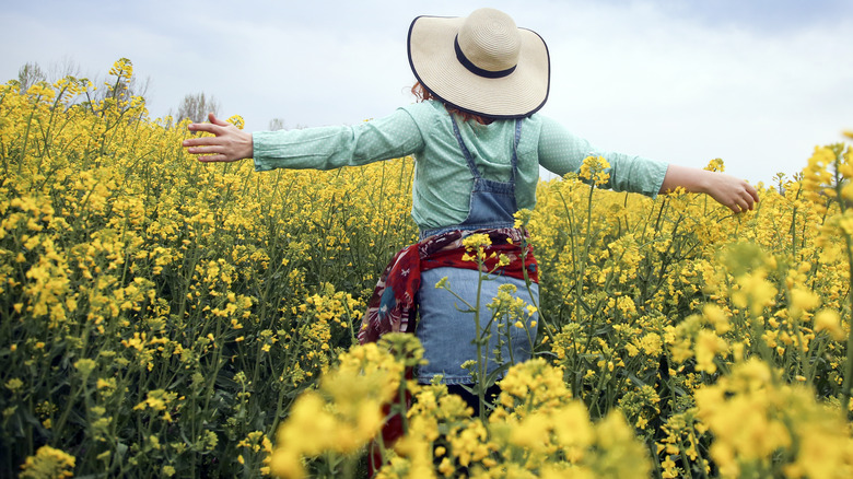 woman walking through flowers