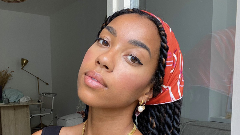 A woman with a bandana on her head