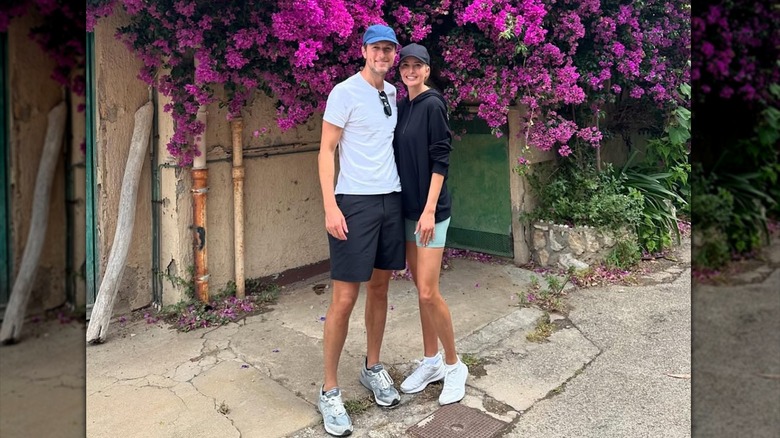 Ivanka Trump posing in bike shorts and a hoodie with Jared Kushner