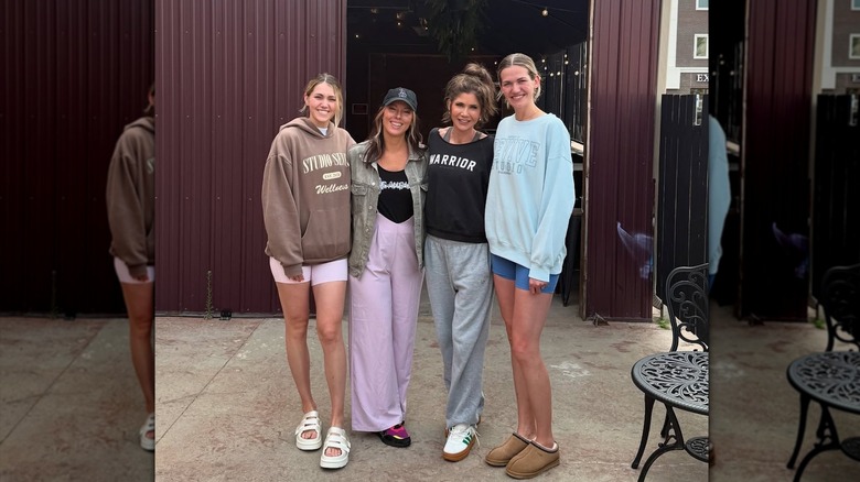 Kristi Noem wearing sweats with trainers and her hair in a messy top knot