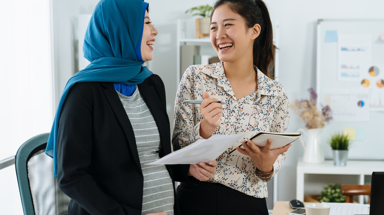 two women laughing at work