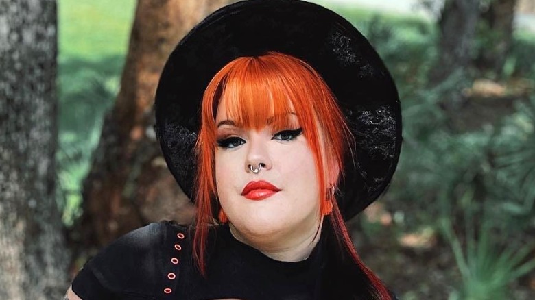 Woman wearing wide-brim black felt hat