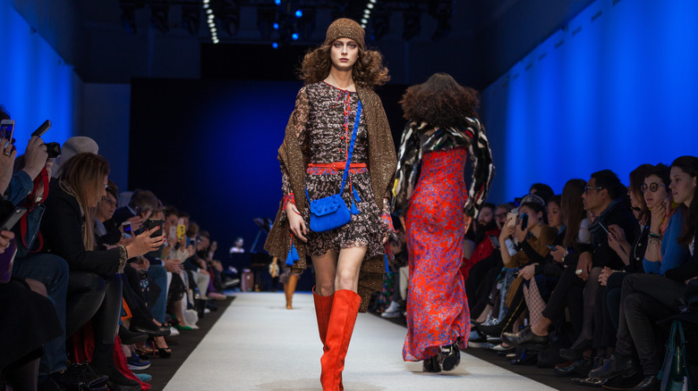 models walking down runway