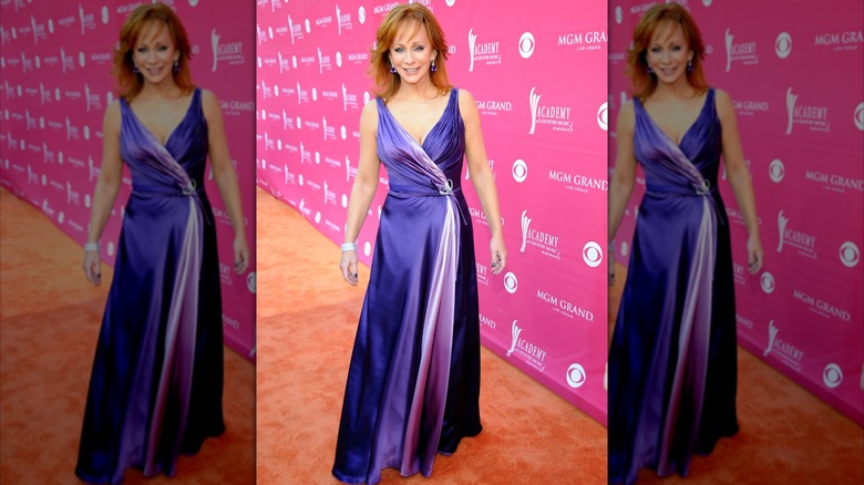 Reba McEntire on the 2009 ACM Awards red carpet in a purple satin dress.