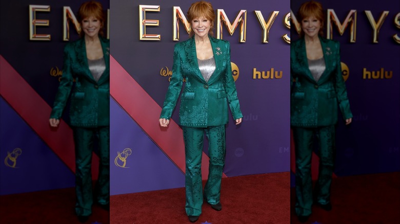 Reba McEntire on the 2024 Emmy Awards red carpet in an emerald metallic suit.