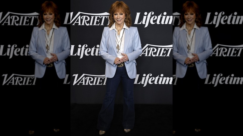 Reba McEntire on the 2025 Variety Power of Women red carpet in a blue blazer and long necklaces
