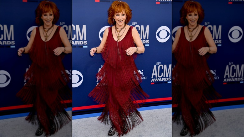 Reba McEntire on the 2019 ACM Awards red carpet in a red fringe dress.