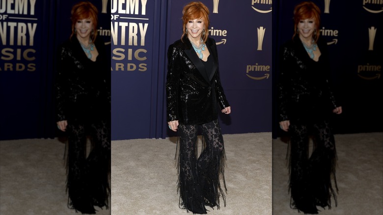Reba McEntire on the 2024 ACM Awards red carpet in a black dress.