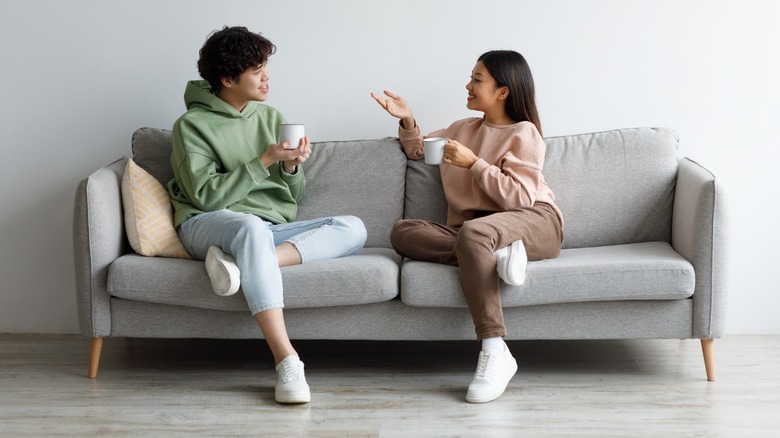 couple drinking coffee on couch