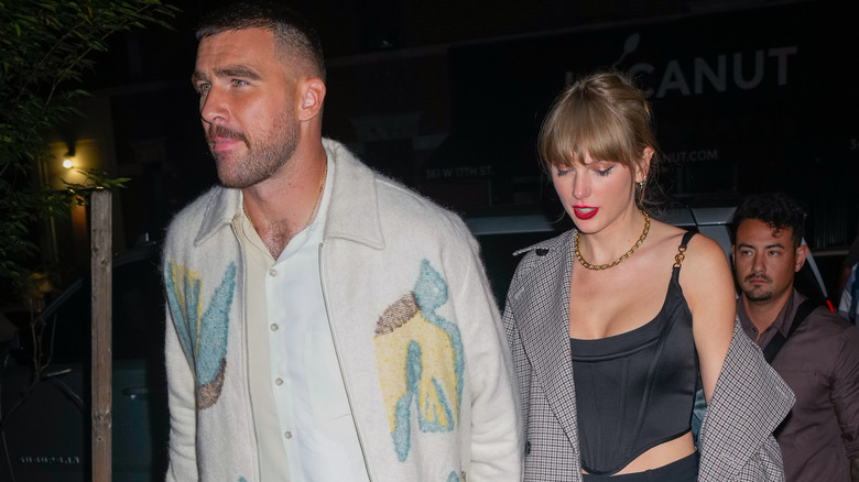 Travis Kelce and Taylor Swift walking on a night out