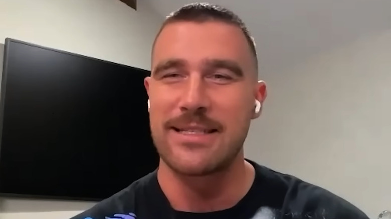 Travis Kelce talking during a podcast interview